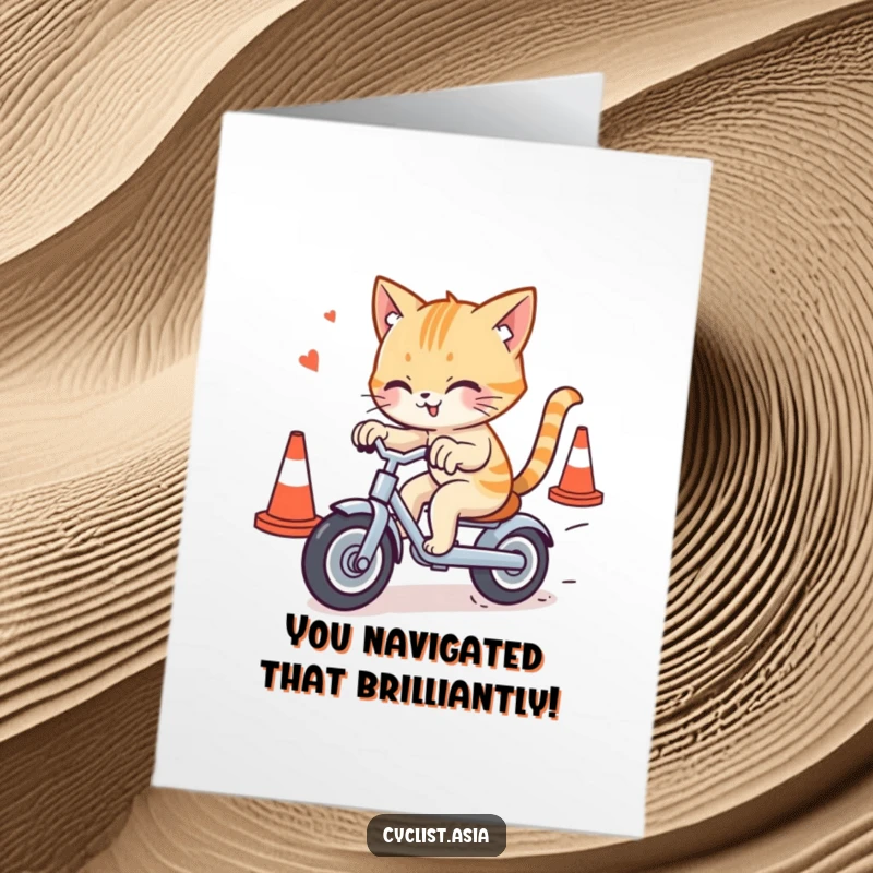 Free Printable Congrats Card: A daring cat masterfully navigating a small tricycle through a gauntlet of traffic cones.