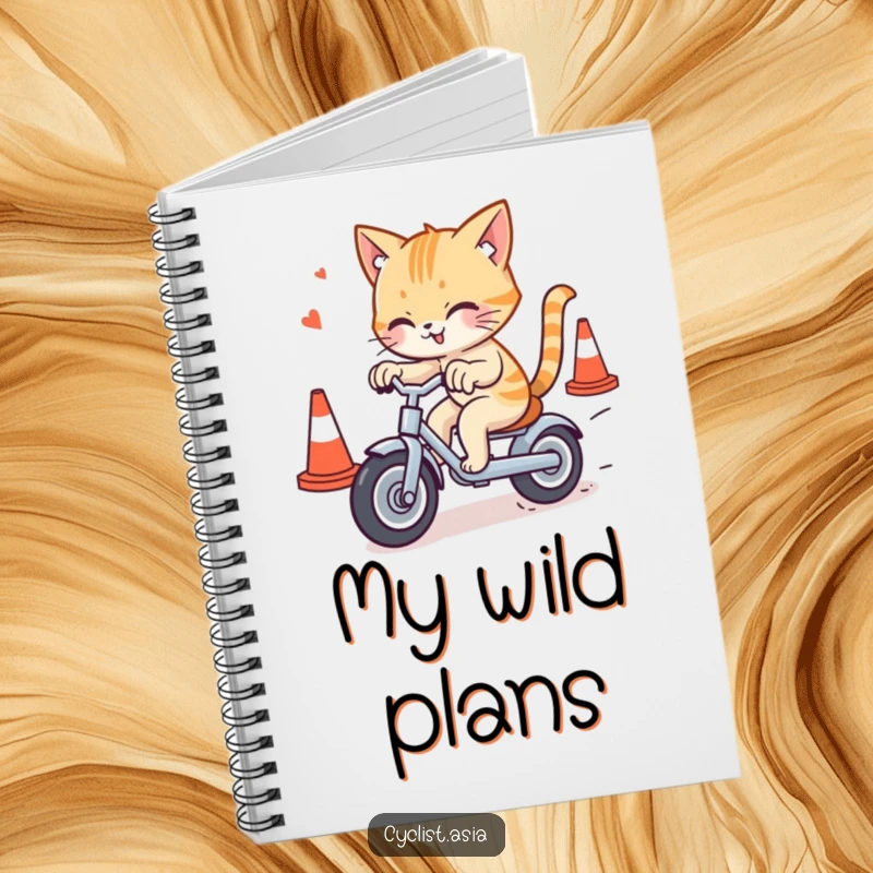 Funny cat notebook featuring a mischievous cat weaving through traffic cones on a tricycle, perfect for jotting down notes with humor.